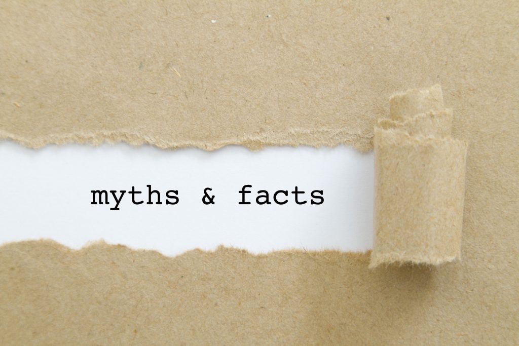 A torn piece of brown craft paper taped over a white background with the words 'myths & facts' visible through the tear. This simple yet powerful image symbolizes the revealing of truth beneath common misconceptions.