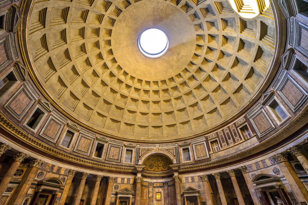 Interior view of the Pantheon's famous coffered concrete dome with a central opening (oculus), showcasing the geometric architectural details and the natural light streaming in, illuminating the ancient Roman temple.