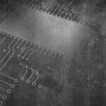 Abstract image of a gray, grunge-styled circuit board pattern with faint, splattered textures. The design includes thin lines and circular connection points, resembling electronic pathways. A large, blurred rectangular area suggests the presence of a central microchip. The image is meant to convey the idea of melding technology in the creation of 3D concrete.