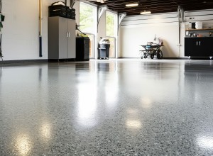 Bright garage interior with polished epoxy floor coating, storage cabinets, and natural light from large open doors