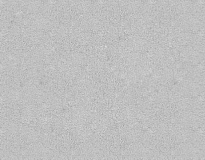 A close-up view of a fine-grained, light grey textured surface resembling concrete or stone.