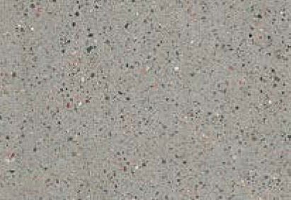 Close-up view of a granular gray surface with a fine distribution of black, white, and occasional colored specks.
