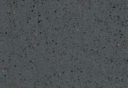 Close-up of a textured surface with a speckled pattern, predominantly in shades of gray with some minute flecks of white and black.