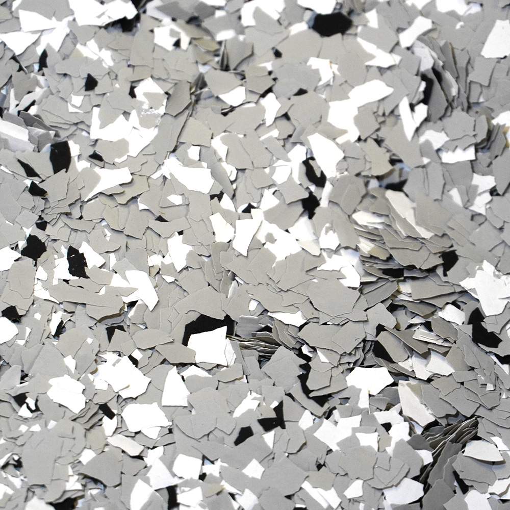 Numerous silver confetti pieces scattered and layered, creating a reflective and metallic texture.
