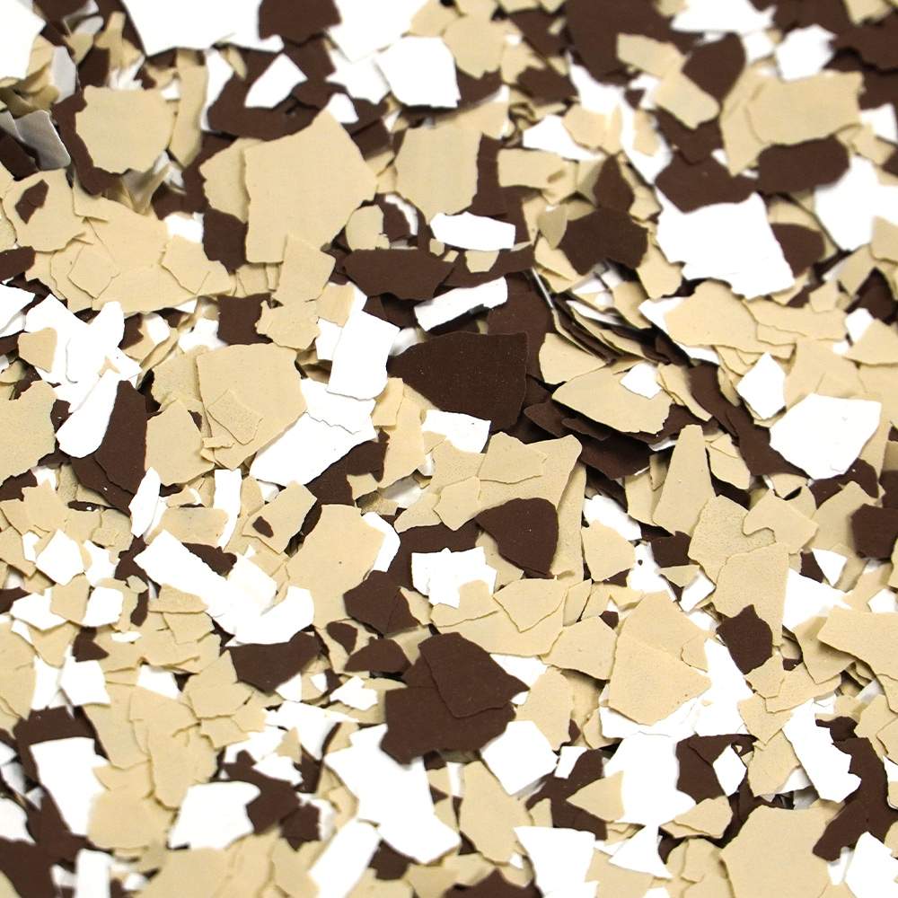 A jumble of broken confetti pieces in shades of white and brown, creating a textured and uneven surface.