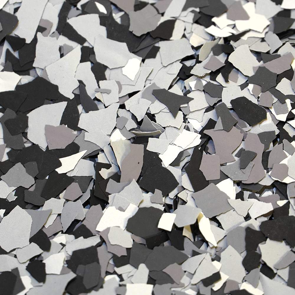 A chaotic spread of black and white confetti pieces creating a contrasting and textured visual effect.